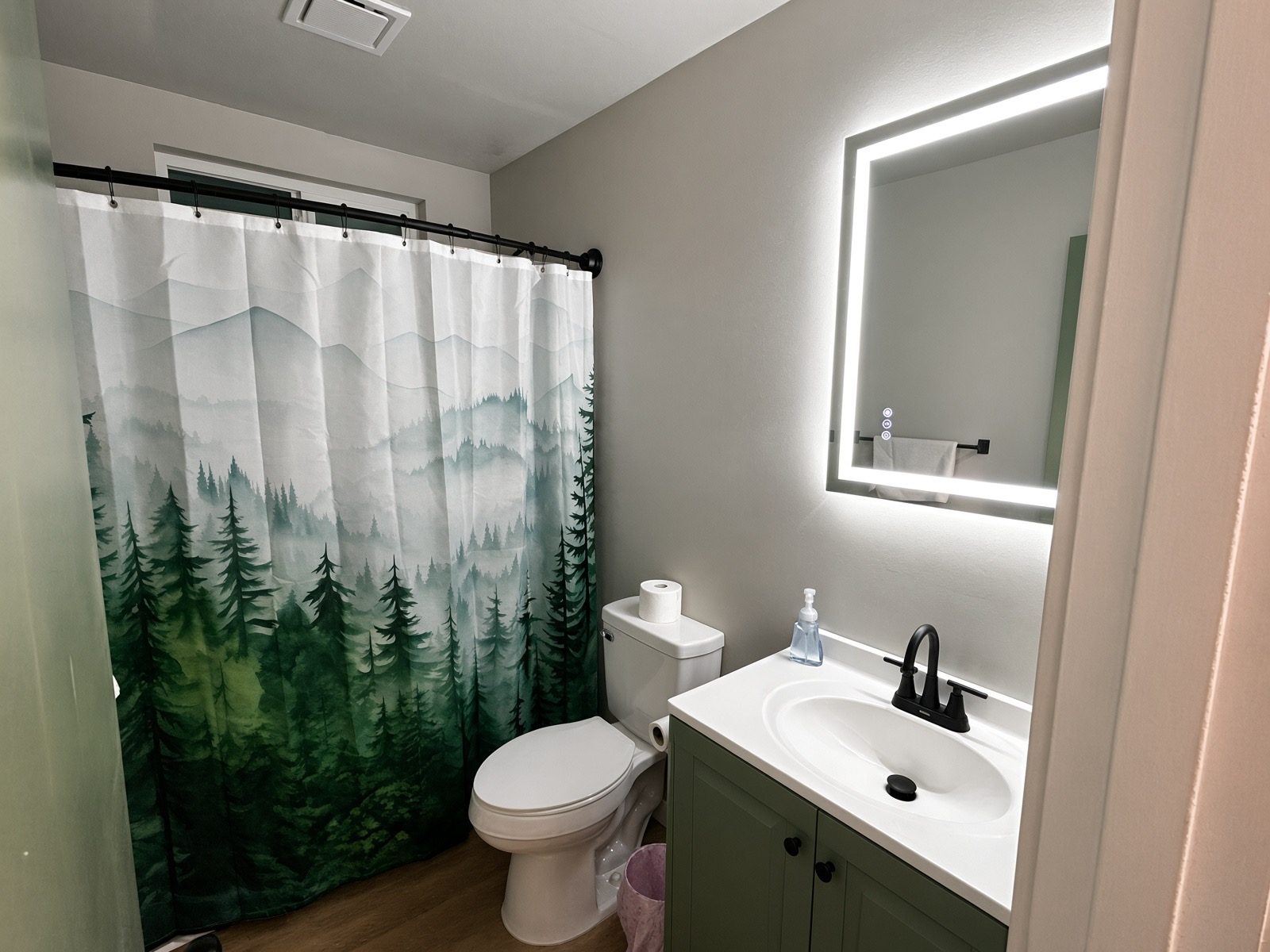 Bathroom with lighted mirror